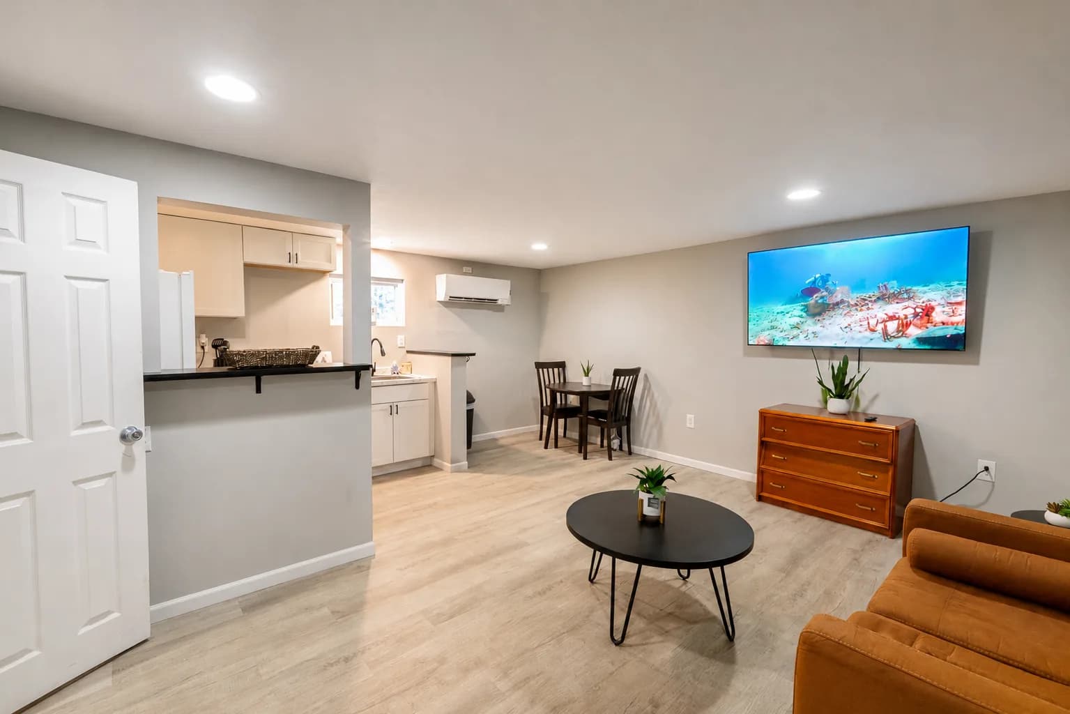Open-plan suite with living area, kitchen and dining table